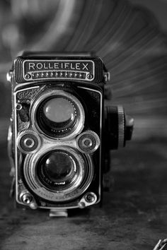 an old camera sitting on top of a table