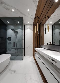 a modern bathroom with marble and wood accents