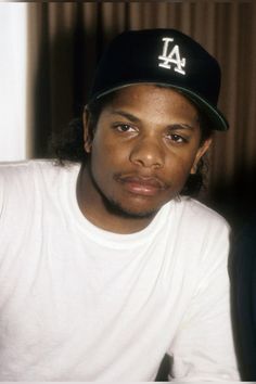 a man wearing a baseball cap sitting down