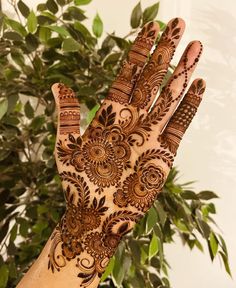 the hand is decorated with henna designs