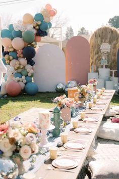 a long table with plates and candles on it