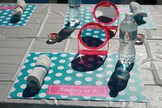 a table topped with lots of different items on top of a blue and white table cloth