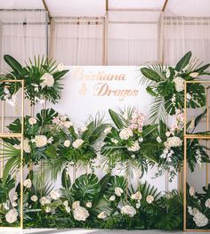 the backdrop is decorated with greenery and flowers