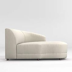 a white couch sitting on top of a white floor