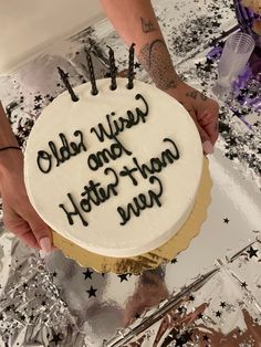 a person holding a cake with writing on it