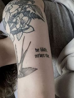 a woman with a tattoo on her arm that says, be illit never eu