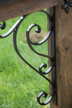 an iron and wood bench in the grass