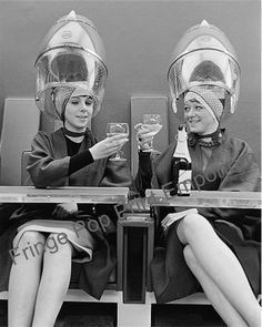 two women sitting next to each other holding wine glasses