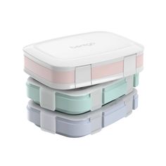 three bento lunch boxes stacked on top of each other, one with the lid closed