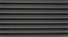 an image of the side of a building that is painted black and white with vertical lines