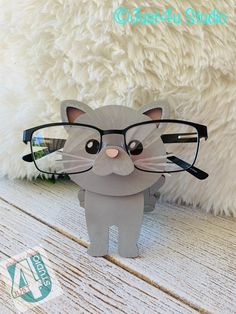 a cat wearing glasses on top of a wooden table