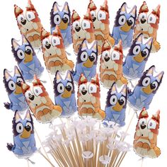 an assortment of cartoon character lollipops on sticks