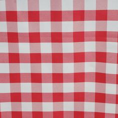 a red and white checkered tablecloth is seen in this close up image,