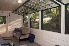 a screened porch with furniture and windows