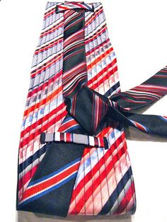 a red, white and blue striped neck tie on a white background with a black bow