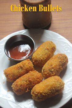 fried chicken balls on a plate with dipping sauce next to it and a jar of ketchup