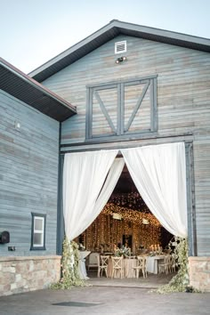 an outdoor venue with white drapes and tables