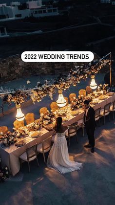 a couple standing in front of a long table with flowers on it and the words, 2012 wedding trends