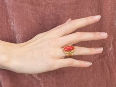 This is a beautiful, Victorian-inspired piece! Organic forms of textured 18k gold frame the deeply saturated coral, while the multi-prong setting holds the cabochon safely in place. The polish on this sumptuous coral is excellent, and makes this ring elegant enough for evening wear! Metal: 18K Yellow Gold Gem: Coral Gem Measurements: 19.4 x 10.4 mm, Oval Ring Size: 6.75 Marks: "750" Stamped on the inside band Coral Stone Ring, Red Coral Ring, Colored Stone Rings, Ring Elegant, Chunky Ring, Gold Statement Ring, Organic Forms, Coral Ring, Gold Jewelry Simple