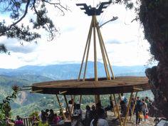 a group of people standing around a wooden structure