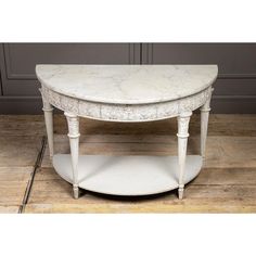 a white marble top coffee table with shelf