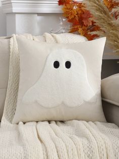 a white pillow with a ghost face on it