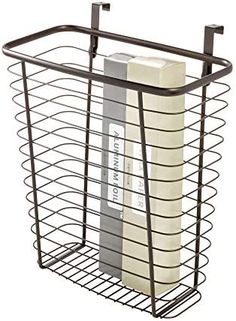 a black wire basket holding two rolls of toilet paper