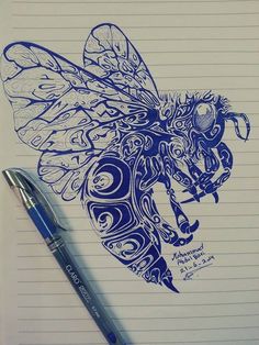 a drawing of a bee on lined paper next to a ballpoint pen and ink