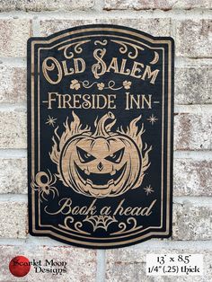 an old salem sign on the side of a brick building with a pumpkin carved into it