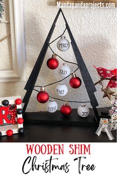 a wooden christmas tree with ornaments on it and the words, wooden shim christmas tree