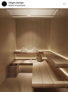 the interior of a spa with wooden benches and lights on each side of the room