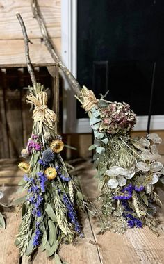 three dried flowers are sitting on the floor