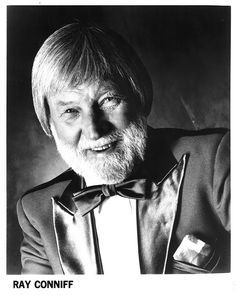 an old black and white photo of a man wearing a suit with a bow tie