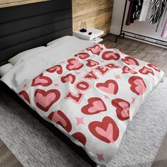 a bed with red and white hearts on it