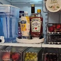 an open refrigerator filled with lots of different types of food and drinks in it's shelves