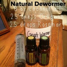 three bottles of essential oils sitting on a table next to an empty bottle with the words natural dewomer