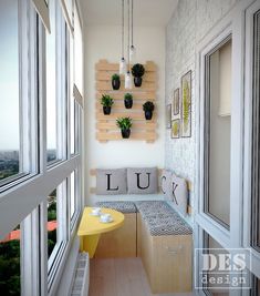 a small room with some plants on the wall and a bench in front of it