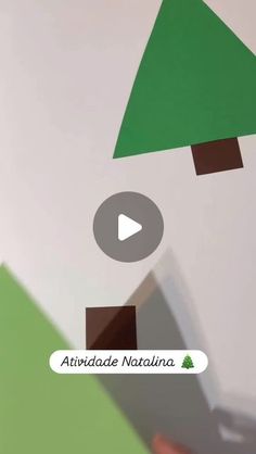 someone is holding a video game with trees on the wall in front of them and an arrow pointing to it