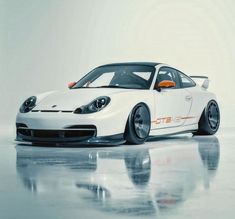 a white sports car parked on top of a shiny floor