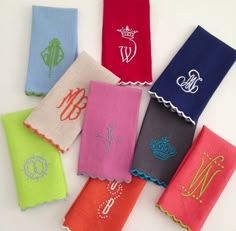 six monogrammed napkins with different colors and designs on them, all in the same design