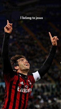 a soccer player is celebrating his goal with the words i belong to jesus above him