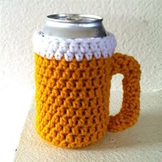 a crocheted coffee cup holder with a beer in the middle on a white surface