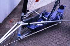 a blue pedal boat sitting on top of a sidewalk