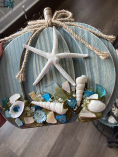 a sea glass ornament with starfish and seashells