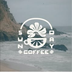 there is a coffee shop logo on the side of a window that has waves crashing in front of it