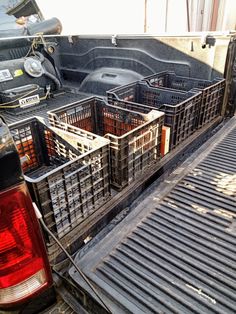 the back end of a truck with crates in it