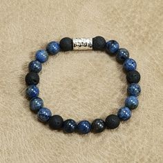 This Bracelet Is A Casual Yet Stylish Bracelet. Can Be Dressed Up With A Suit Or Down With Denim. Comprised Of 10mm South African Dumortierite (Blue) Beads, Black Lava Beads, And A Silver Hammered Metal Accent Bead. Approx 8.5" Long Please Note: When Putting On A Non-Clasp Or Stretch Bracelets, Always Roll It On. Directions: While Keeping Your Hand Opened, Fingers Together, And Your Thumb Tucked In Your Palm, Roll Your Bracelet On. Do The Same Thing When Taking It Off. This Will Help Increase Th Blue Casual Bracelet For Meditation, Casual Blue Bracelet For Meditation, Adjustable Blue Bracelets With Black Beads, Horseshoe Earrings, Lava Bead Bracelet, Flower Purses, Blue Beaded Bracelets, Lava Beads, Stylish Bracelet