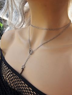 This is a dainty minimalist steel Lariat Necklace Set wrap gothic grunge punk aesthetic choker with Spike pendant.  The minimalist design gives it a trendy and stylish feel, while the steel gives it a touch of gothic Punk edge. It is waterproof sweatproof non-tarnish and hypoallergenic.  This necklace is versatile and can be worn long or doubled up for a layered look. This is a dainty chain, but is strong steel. is you are looking for someone more suitable to "fun and games" please take a look i Trendy Handmade Lariat Jewelry, Punk Necklace With Lobster Clasp As Gift, Punk Style Nickel-free Necklace For Gifting, Nickel-free Stainless Steel Charm Necklaces, Edgy Stainless Steel Choker Necklace, Dainty Silver Lariat Choker Necklace, Punk Metal Jewelry For Gifts, Edgy Chain Jewelry Gift, Edgy Chain Jewelry For Gifts