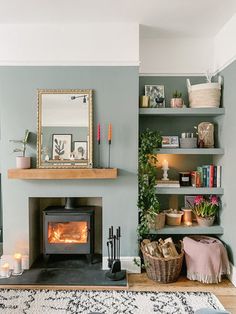 a living room filled with furniture and a fire place in front of a mirror on the wall