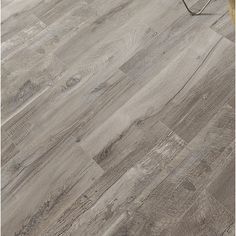 an image of a wooden floor that looks like it has been painted in grey and white